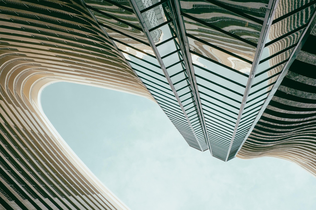 Curving residential balconies rising against a pale sky
